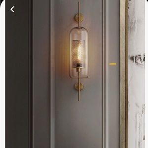 2 brand new and never installed sconces. Gold color 120 V and 40.00 Wattage